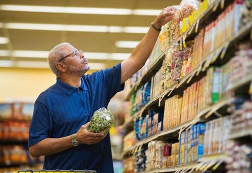 Man reaching for cereal at grocery store