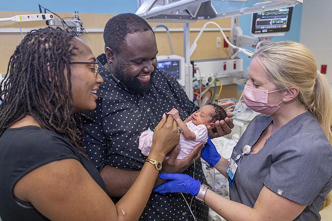 Parents Caprice and Marcus with baby Ari in the neonatal intensive care unit (NICU) at Johns Hopkins All Children's.